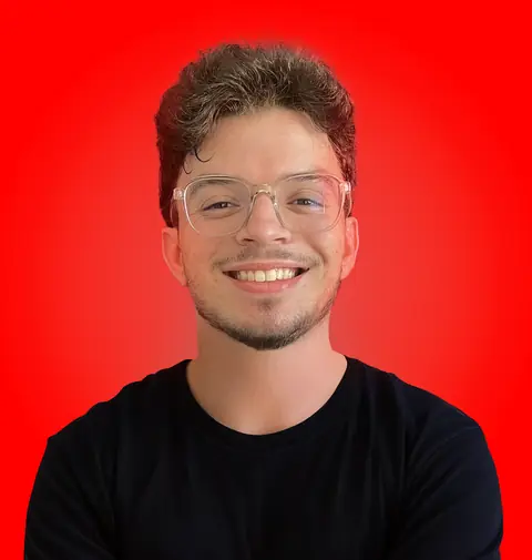 Yessine Akrout smiling against a red background